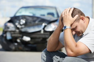 Man in front of crashed cars needing car insurance in Kokomo, IN 